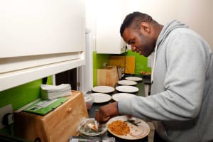 Young person preparing food in kitchen at Charlotte House